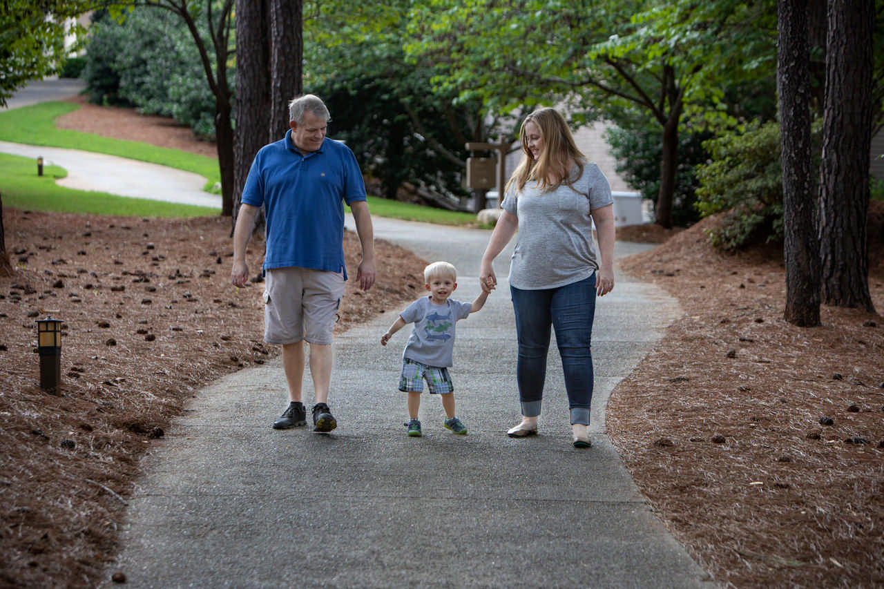 couple walking with toddler boy between them during a JAJF WOW experience 