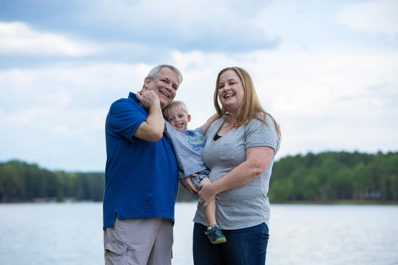 couple holding toddler boy between them during a JAJF WOW experience 