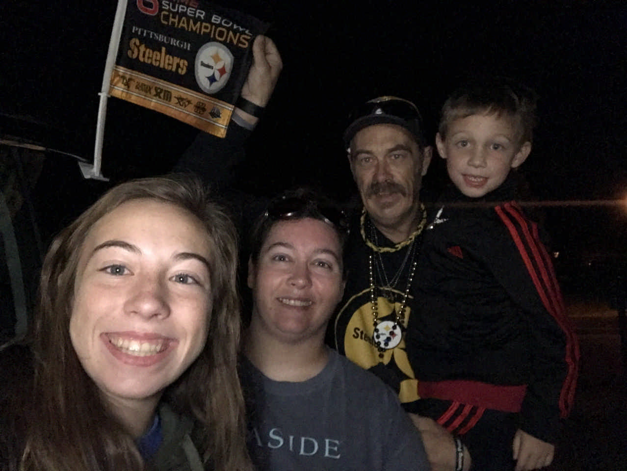family with a Pittsburgh Steelers flag during a Jack and Jill Foundation WOW experience 