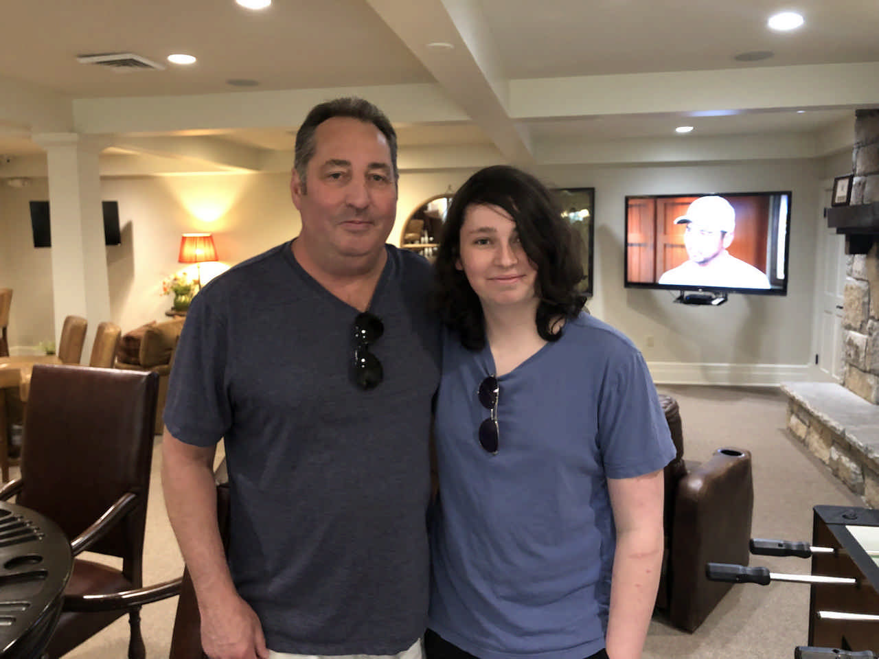 father and son taking a picture in a game room during a Jack and Jill Foundation WOW experience 