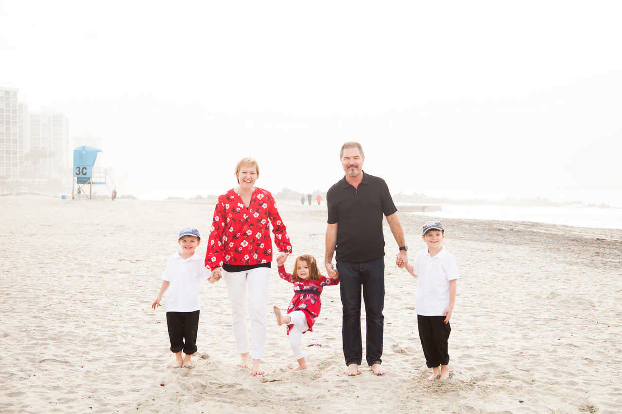 family holding hands while on the beach during a Jack and Jill Foundation WOW experience 