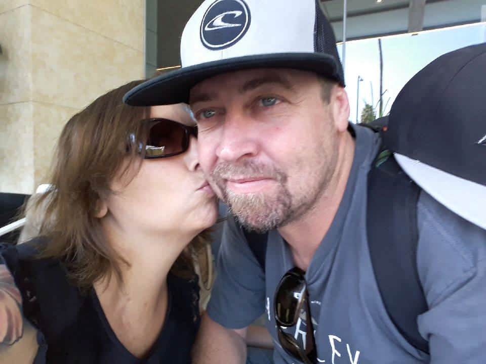 wife kissing husband on the cheek during a JAJF WOW experience 