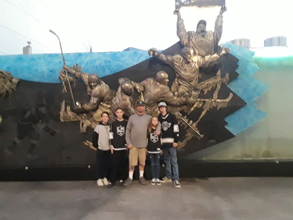 family at LA Kings hockey stadium enjoying a JAJF WOW experience 