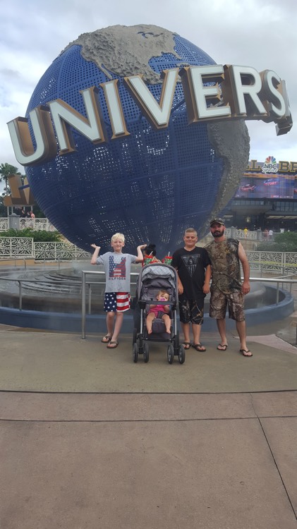 family in front of Universal Studios on a JAJF WOW experience 