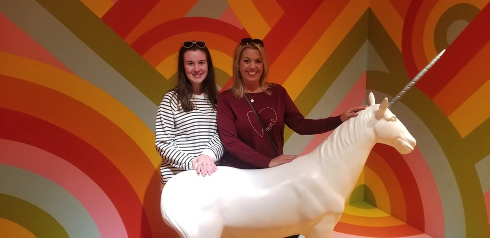 mom and daughter with unicorn statue during a JAJF WOW experience 