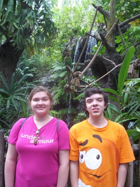 brother and sister in front of palm trees enjoying The Power of WOW experience 