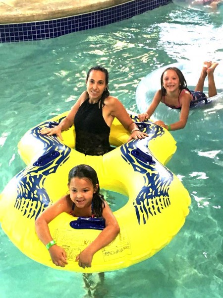 mom and daughters in inner tubes on lazy river enjoying a JAJF WOW experience 