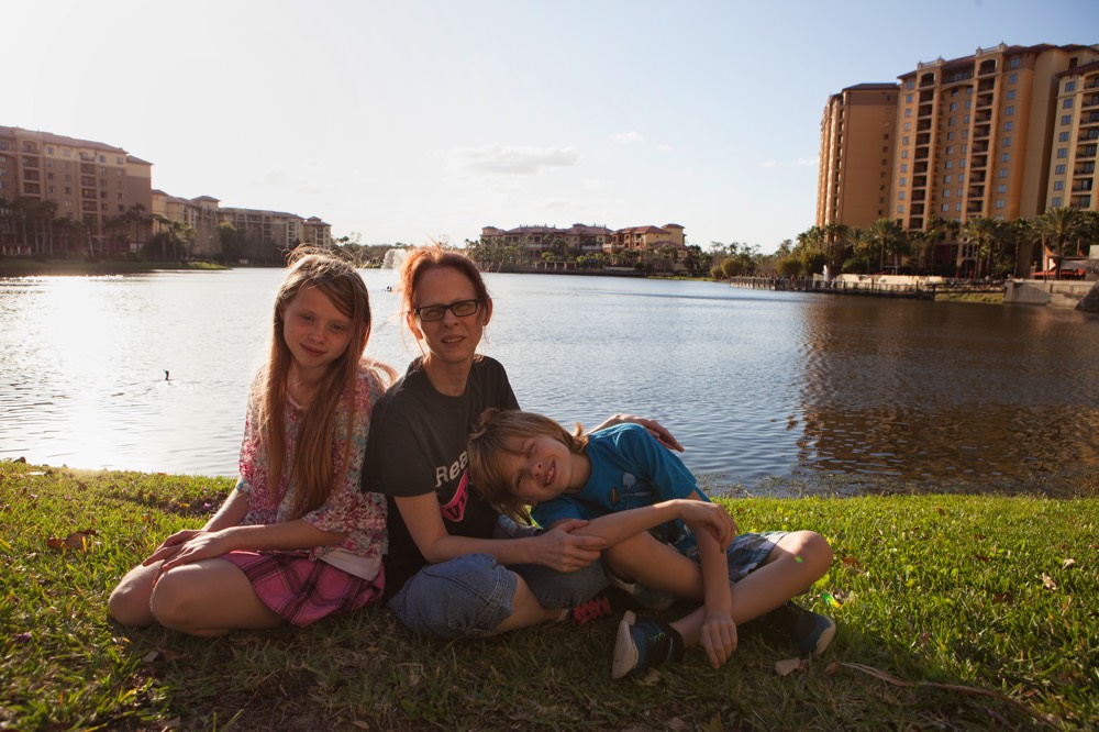 mom and children sitting beside pond enjoying a JAJF WOW experience 