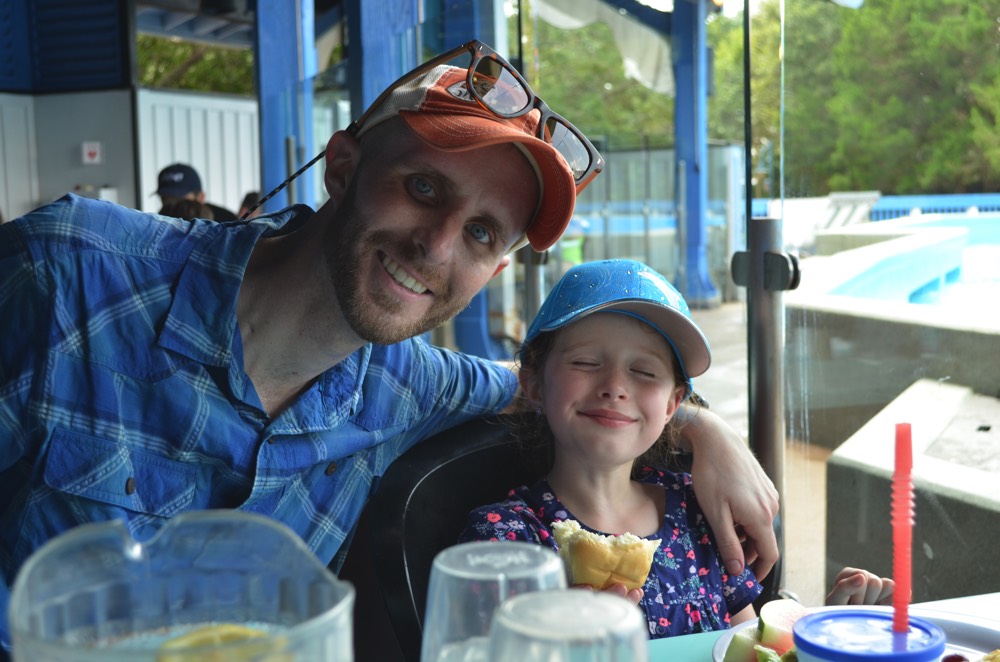 dad and daughter eating at restaurant during a JAJF trip treating the families not the cancer 
