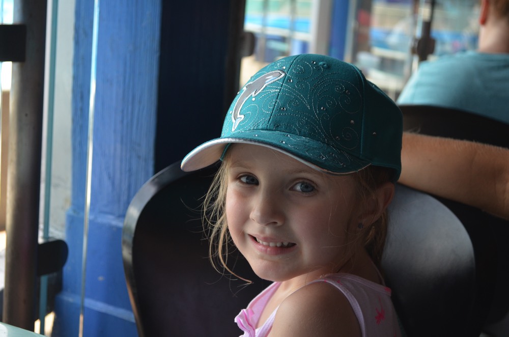 young girl wearing light blue hat during a JAJF trip treating the families not the cancer 