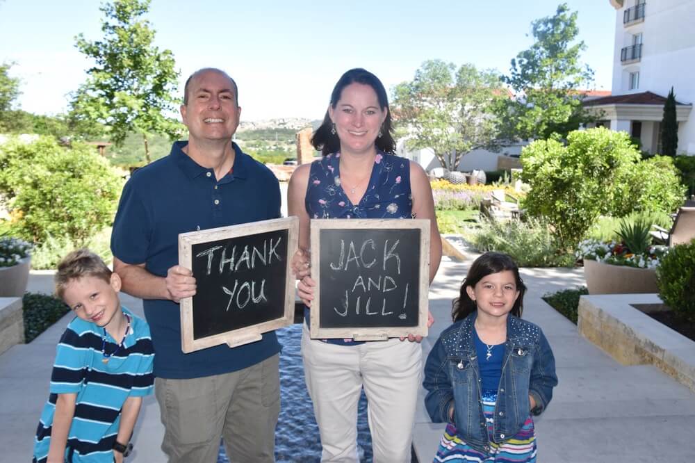 family holding chalkboards thanking JAJF 