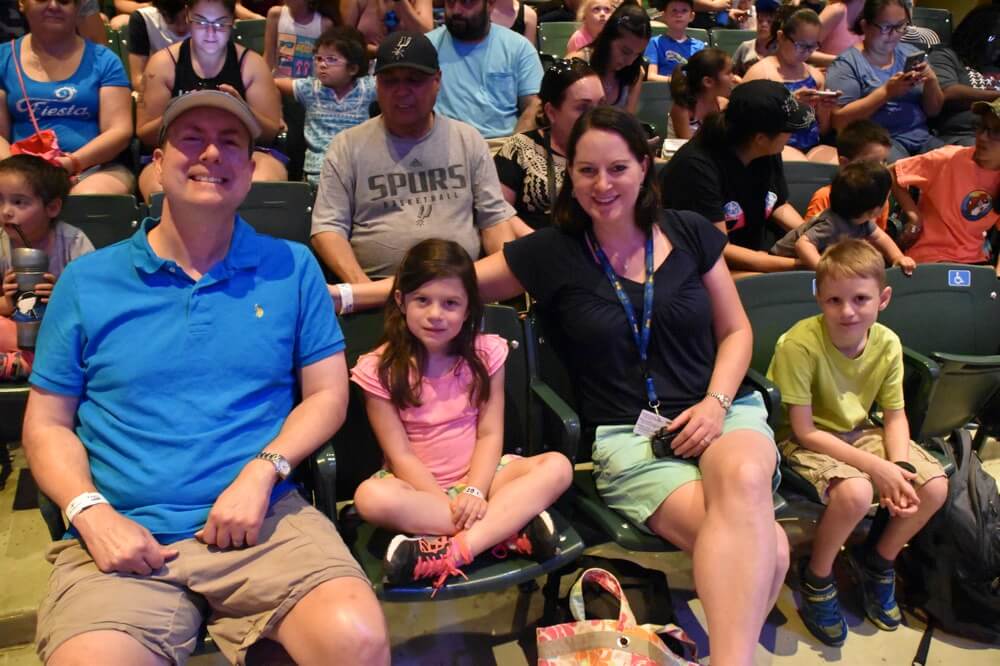 family in theater enjoying The Power of WOW experience 