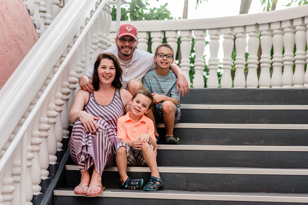 family sitting on steps on a JAJF WOW experience 
