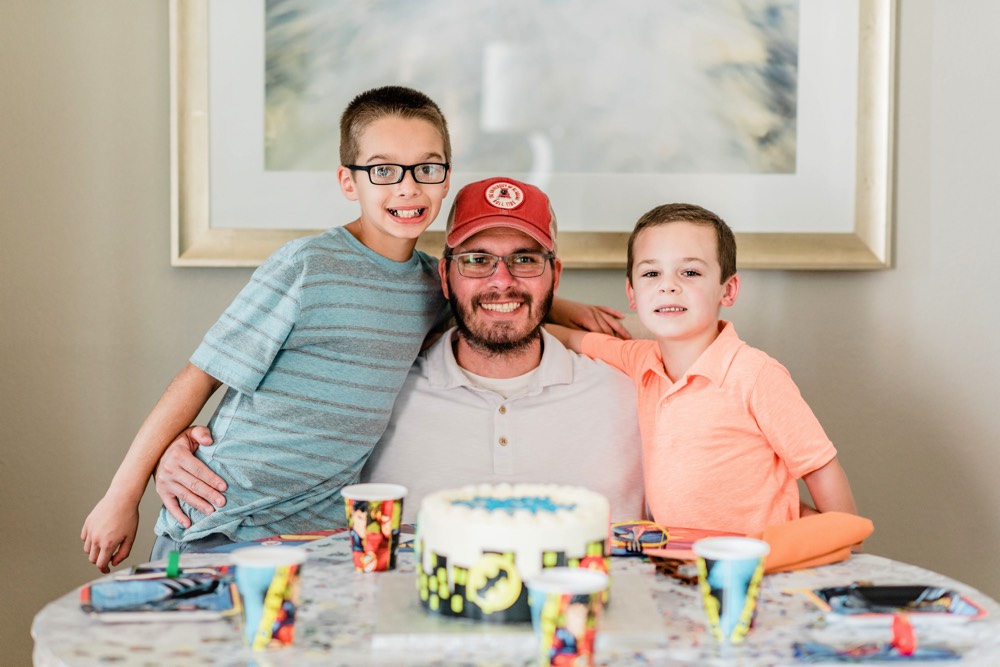 dad with two sons enjoying birthday cake on a JAJF WOW experience 