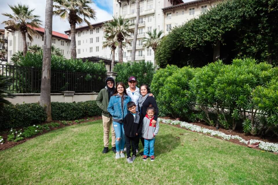 family posing outside on lawn enjoying The Power of WOW experience 