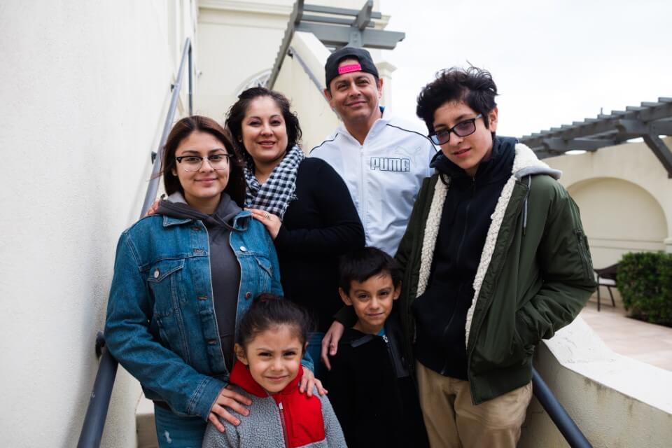 family posing on stairs enjoying The Power of WOW experience 