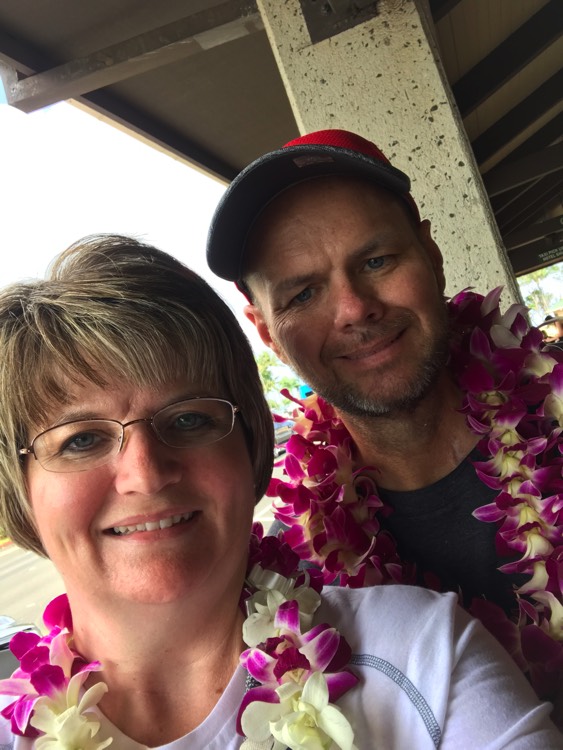 husband and wife wearing pink leis during a JAJF trip treating the families not the cancer 