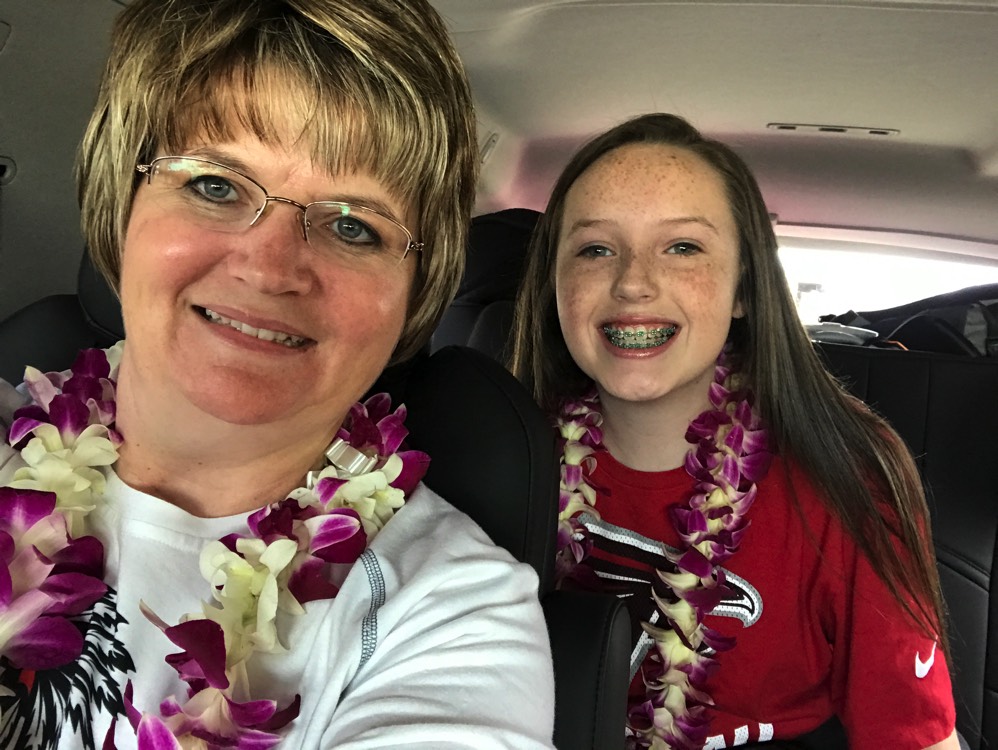 mom and daughter wearing leis in Hawaii during a JAJF trip treating the families not the cancer 