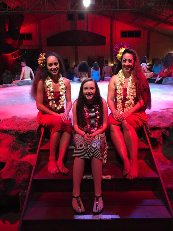 young girl with luau dancers in Hawaii during a JAJF trip treating the families not the cancer 