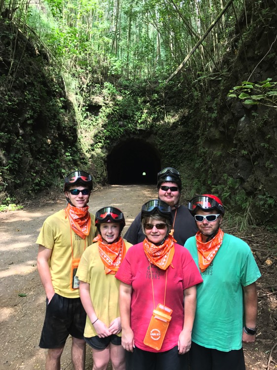 family of five wearing helmets and orange bandanas around neck during a JAJF trip treating the families not the cancer 