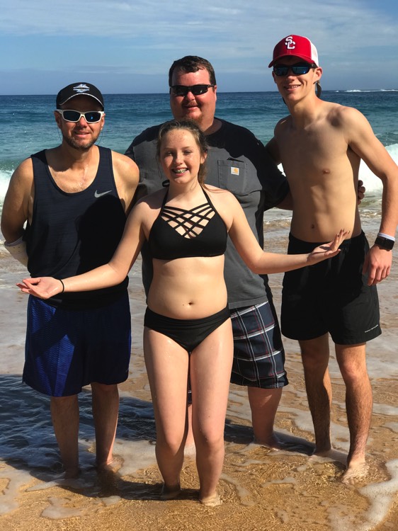 young girl in black bikini with family at the beach during a JAJF trip treating the families not the cancer 