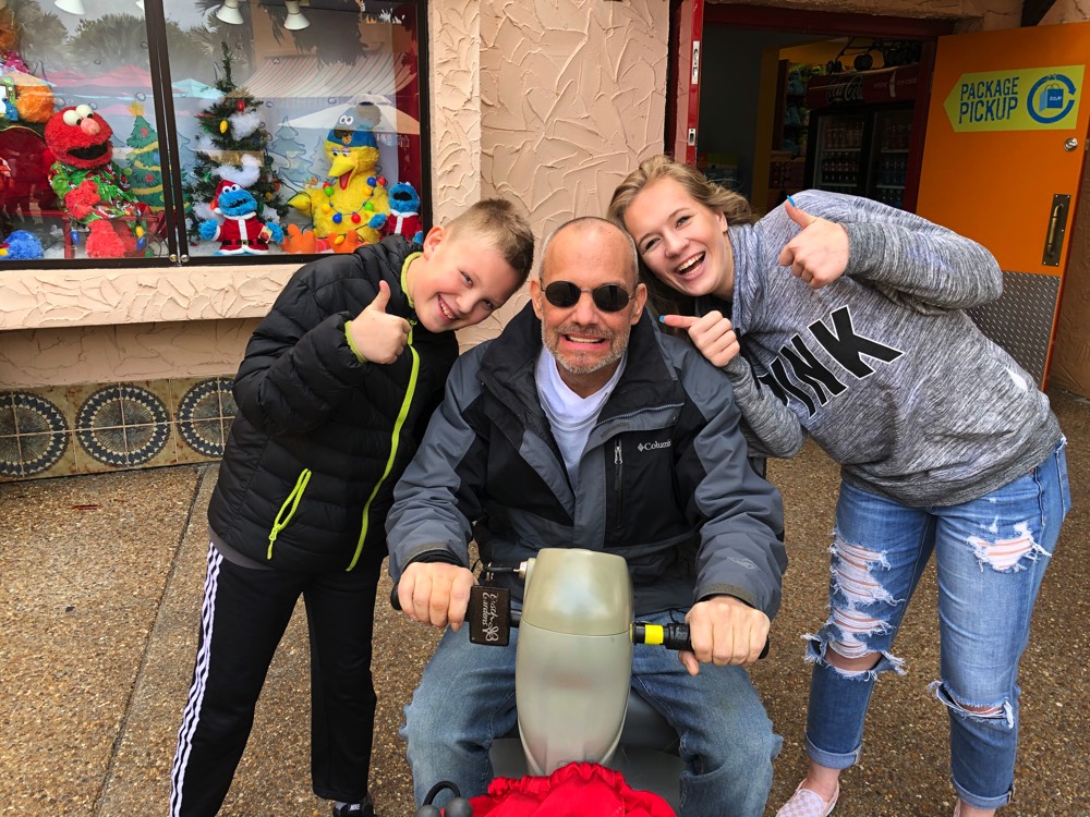 children with dad giving thumbs up signs on a JAJF WOW experience 