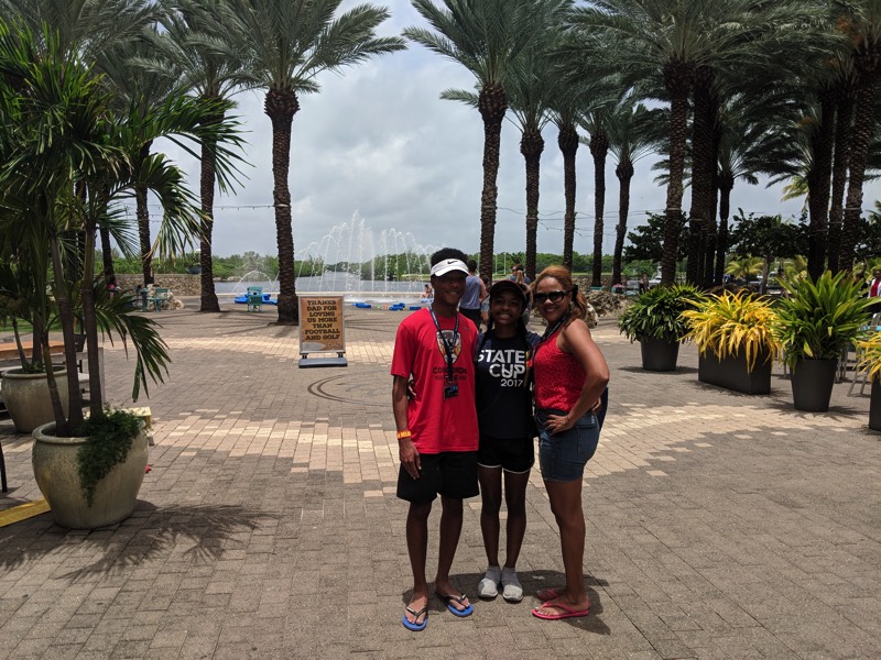 mom with children on beach with palm trees enjoying a JAJF WOW experience 