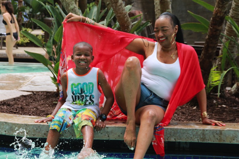 mom and son with feet in the pool enjoying a JAJF Wow Experience 
