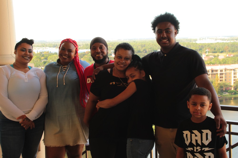 family on hotel balcony enjoying a JAJF WOW experience 