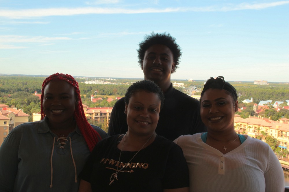 family on hotel balcony enjoying a JAJF WOW experience 