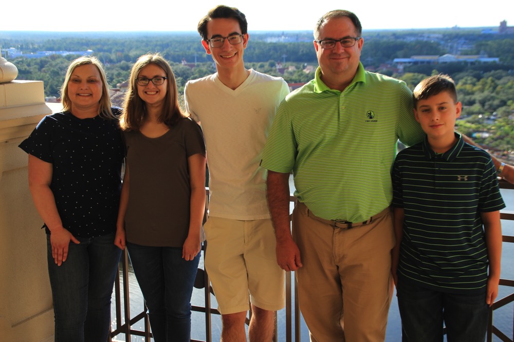 family on balcony overlooking city enjoying a JAJF break from late stage cancer 