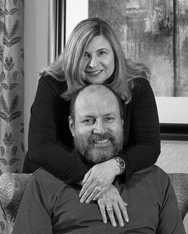 wife hugging husband from behind during a JAJF trip treating the families not the cancer 