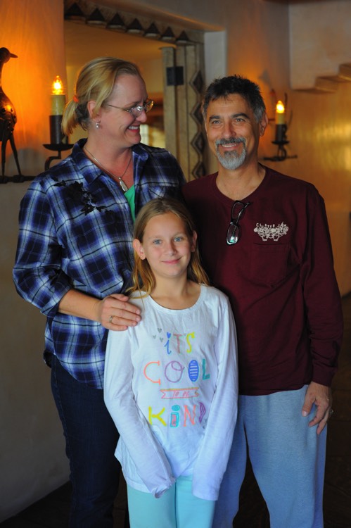 mom and dad with daughter in hotel room on a JAJF WOW experience 