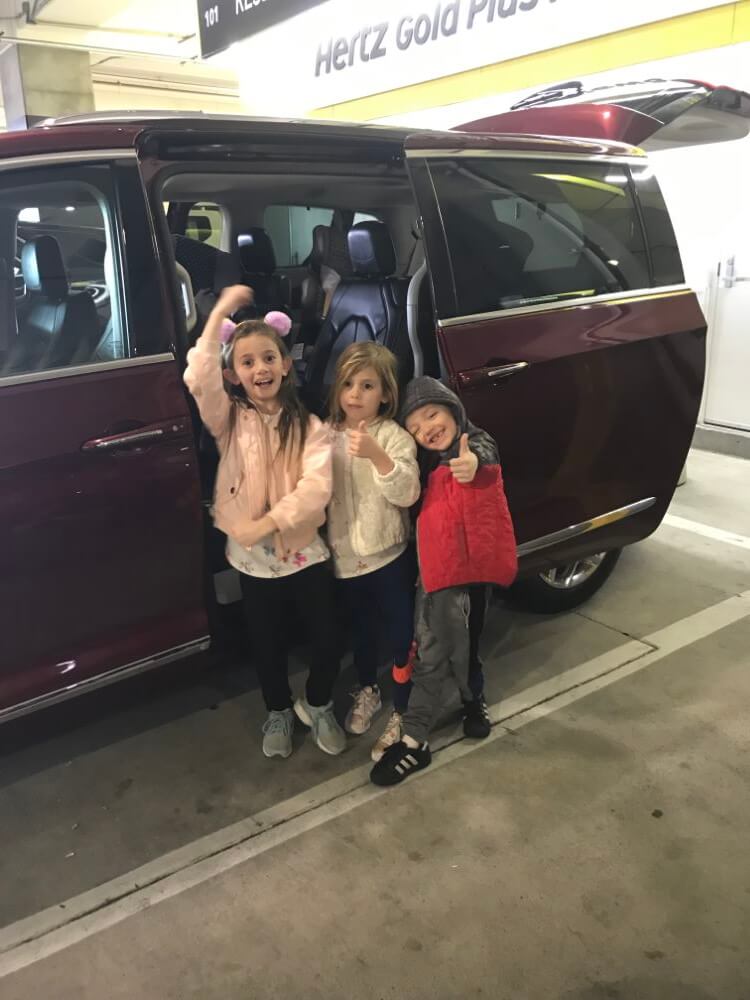 children in front of maroon van enjoying The Power of WOW experience 