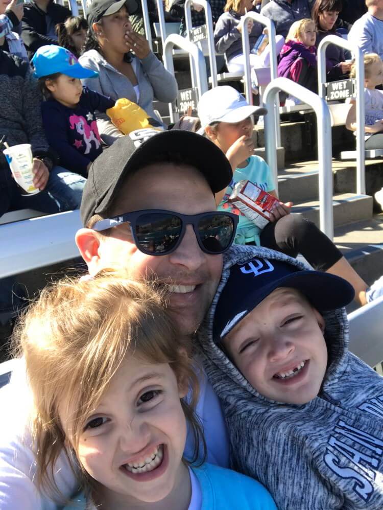 father with children at SeaWorld show enjoying The Power of WOW experience 