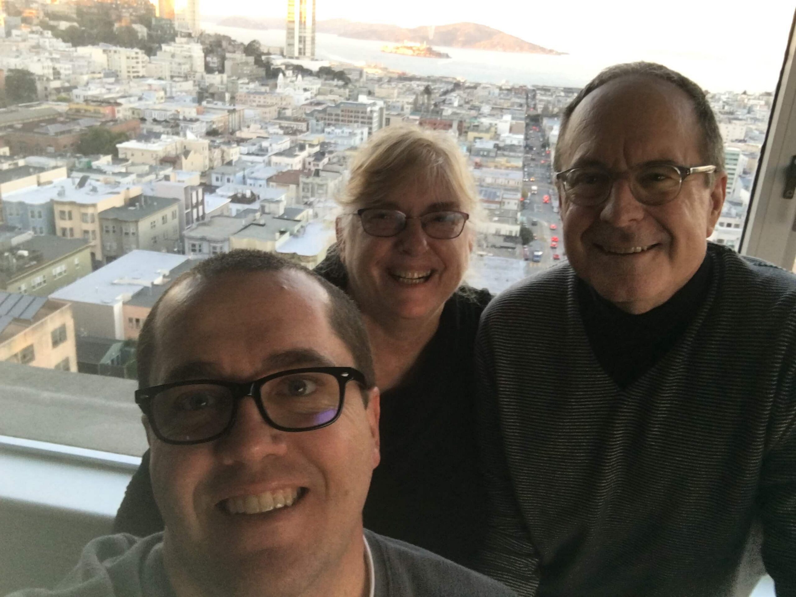 three adults taking selfie overlooking city enjoying The Power of WOW experience 
