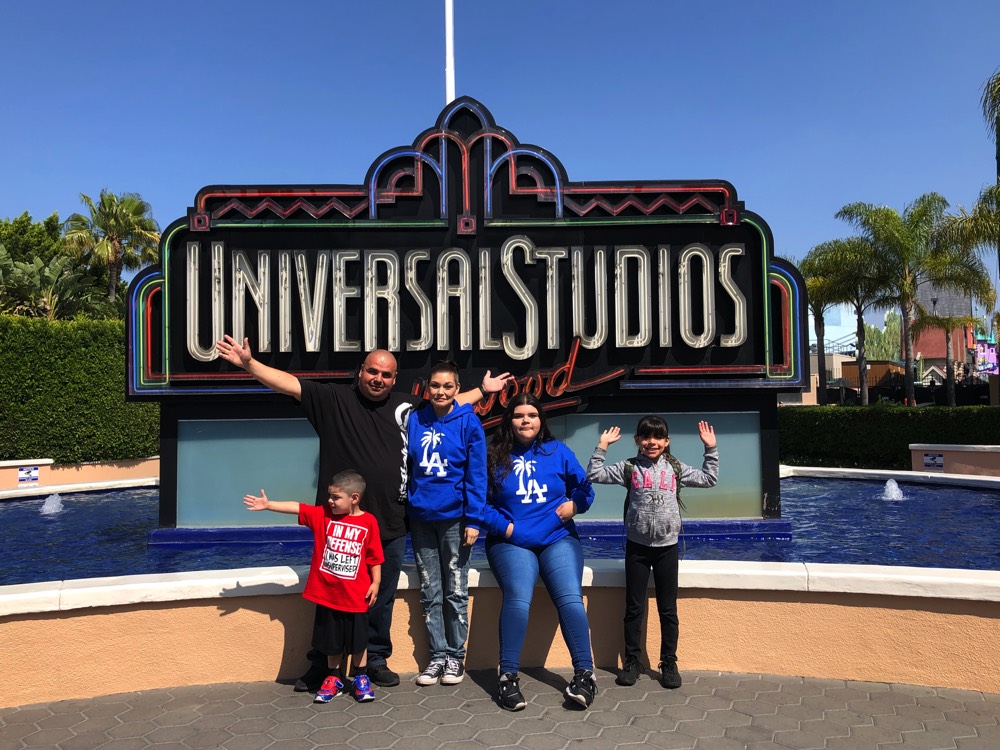 family in front of Universal Studios on a JAJF WOW experience 