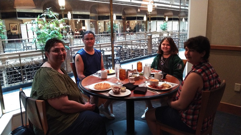 family of four eating in a restaurant on a JAJF WOW experience 