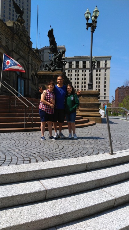 mom and father with daughter in front of building on a JAJF WOW experience 