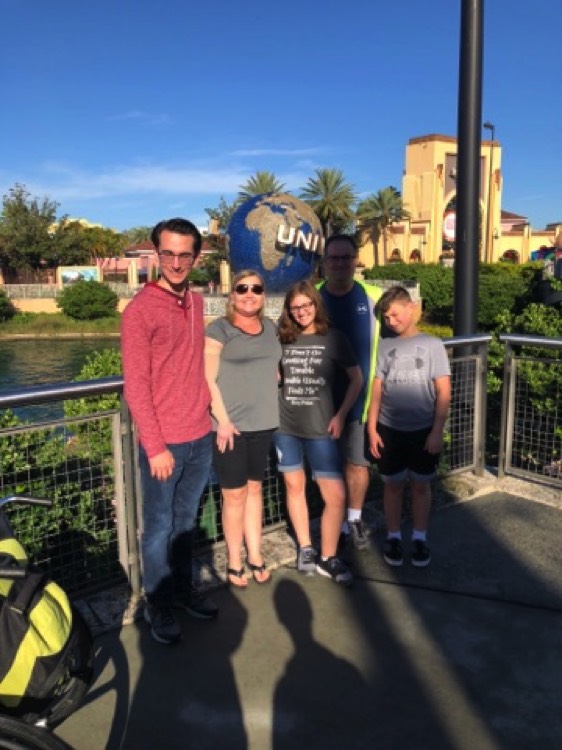family in front of Universal Studios on a JAJF WOW experience 