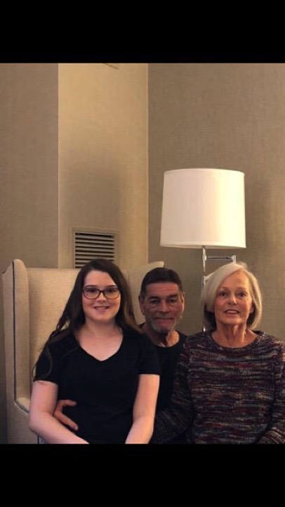 family posing on chair enjoying The Power of WOW experience 