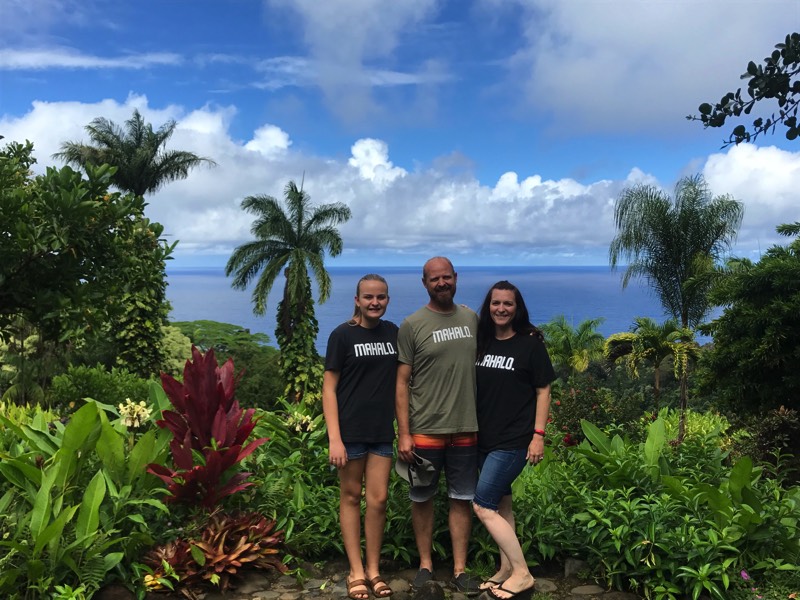 mom and dad with daughter in tropical setting enjoying a JAJF WOW experience 