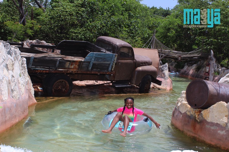 girl in pink swim shirt on inner tube going down lazy river enjoying a JAJF WOW experience 