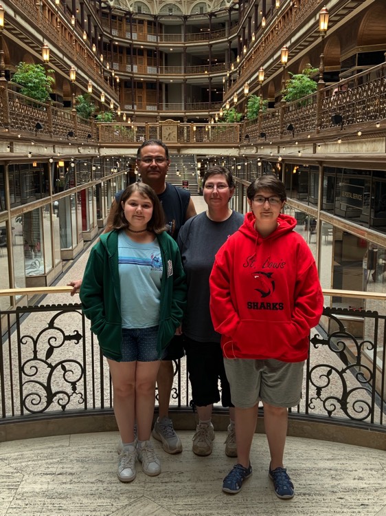 family standing on indoor balcony enjoying the Power of WOW 