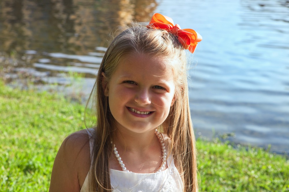 young girl with orange bow on a JAJF WOW experience 