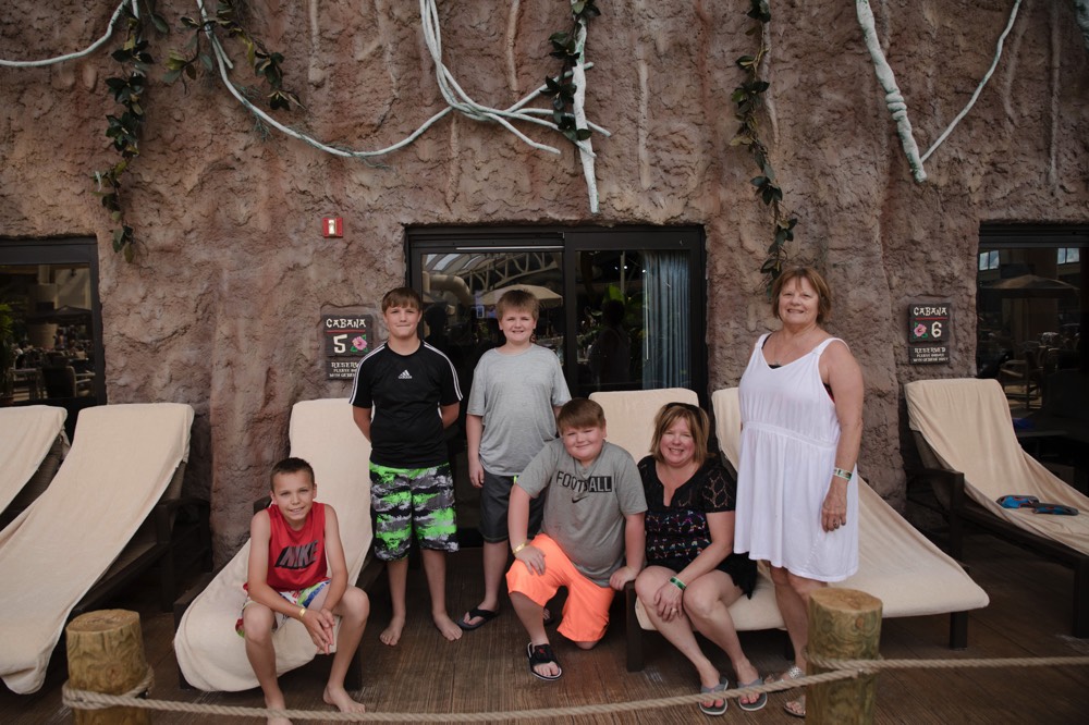 family poolside on lounge chairs enjoying a JAJF WOW experience 