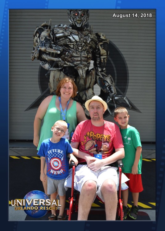 mom and young boys next to dad wearing Popeye shirt during a JAJF trip treating the families not the cancer 