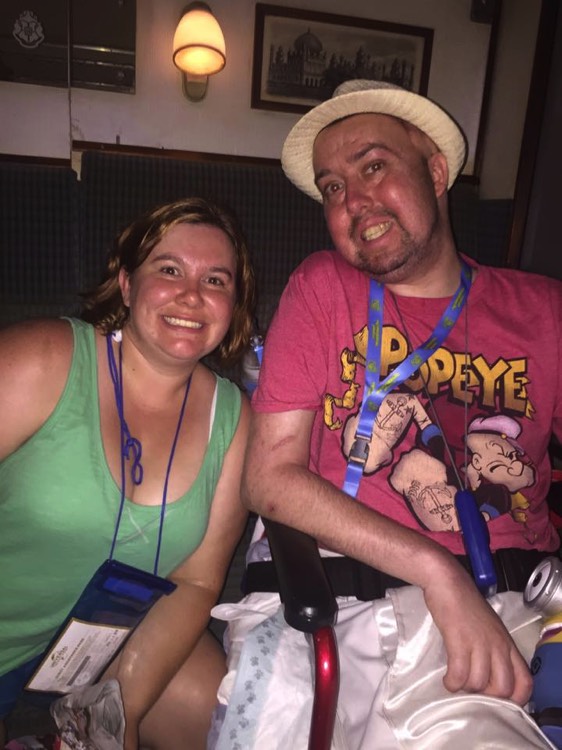 couple smiling with husband wearing a Popeye shirt during a JAJF trip treating the families not the cancer 