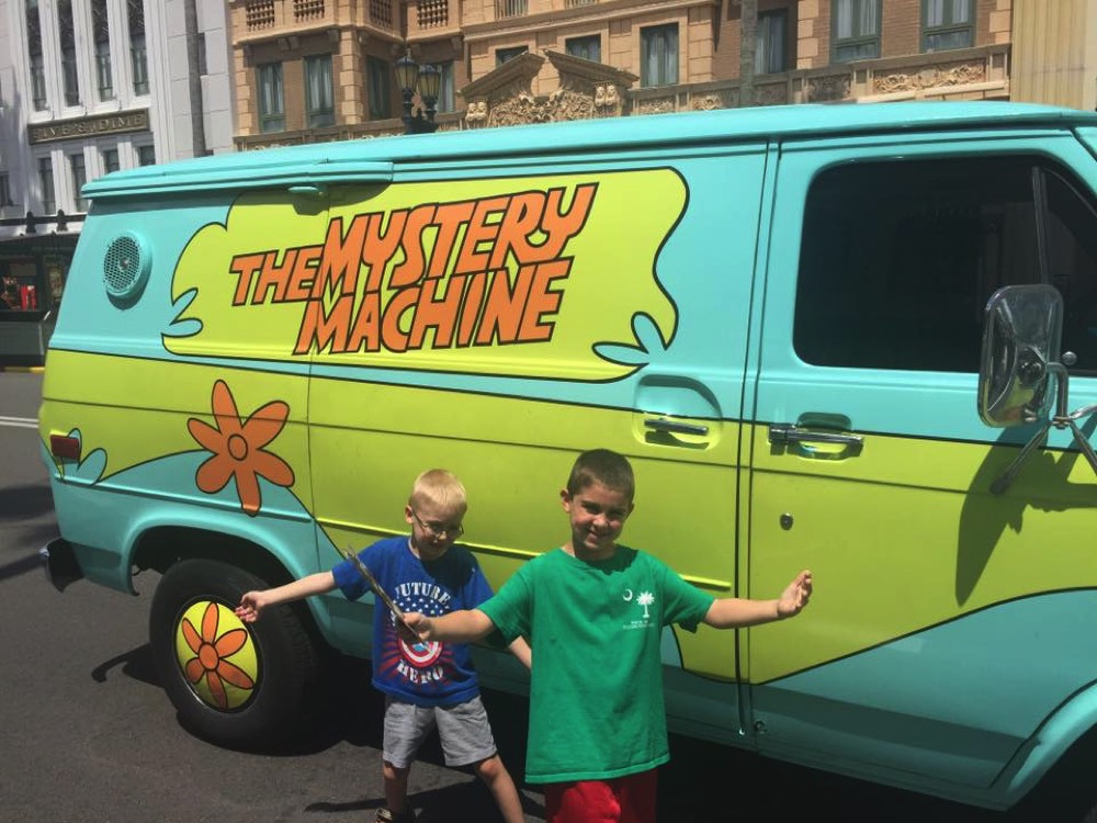 two young boys next to The Mystery Machine during a JAJF trip treating the families not the cancer 